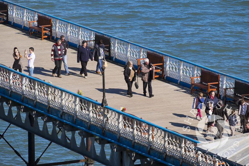 Visitors enjoy the sunshine on Llandudno Pier, north Wales.