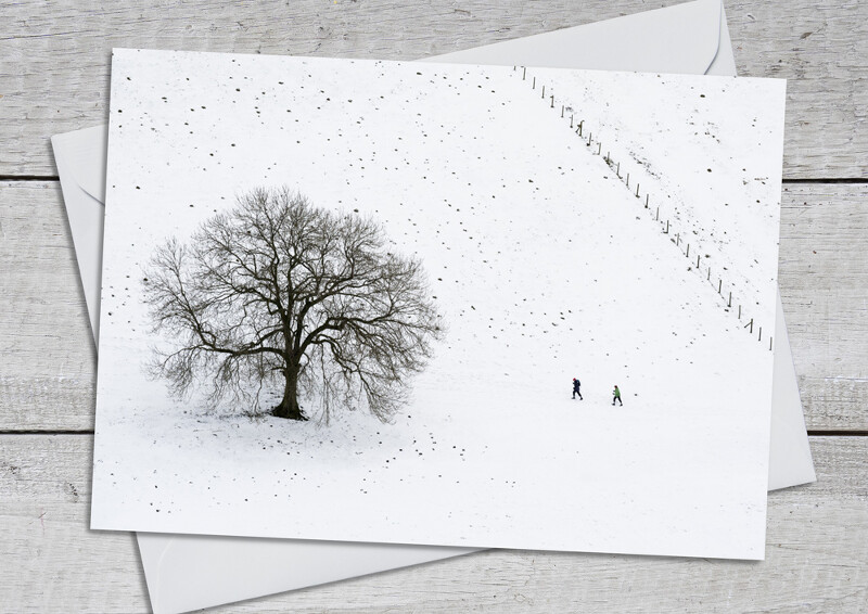 Walkers in the snow on Hope Bowdler Hill, Shropshire.