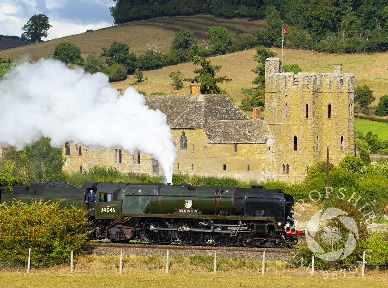 Steam engine 34046 Braunton pulls the Welsh Marches Express past Stokesay Castle in Shropshire.