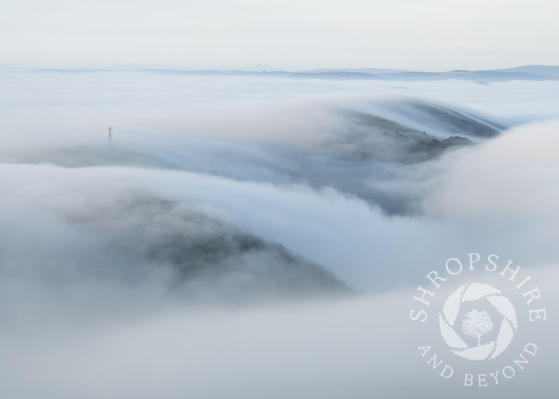 A blanket of fog envelops Helmeth Hill, and Hazler Hill, seen from Caradoc, Shropshire.
