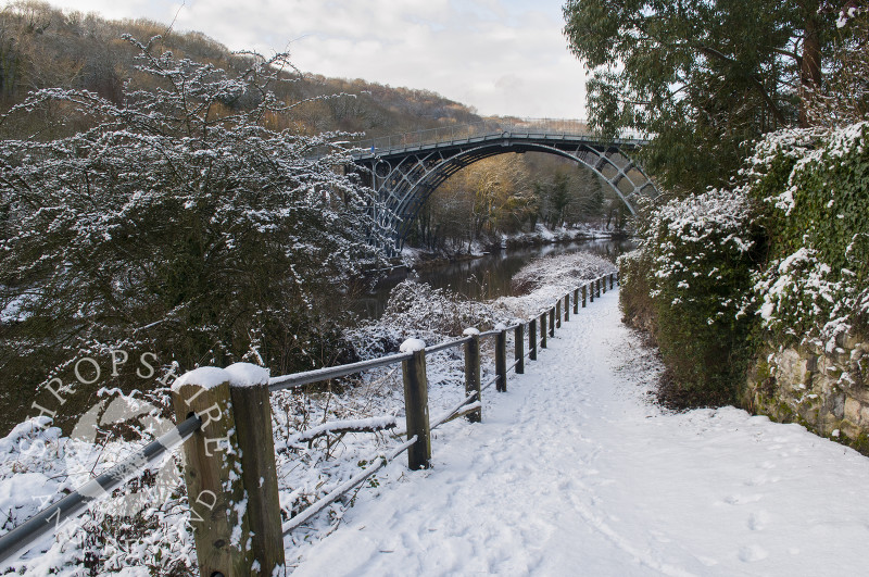 Footprints in the snow leading to the Iron Bridge at Ironbridge, Shropshire, England.