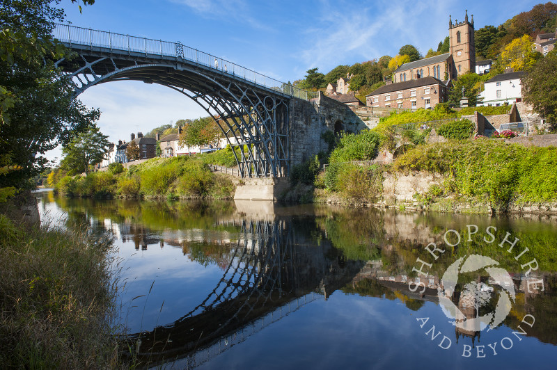 The Iron Bridge reflected in the River Severn at Ironbridge, Shropshire, England.