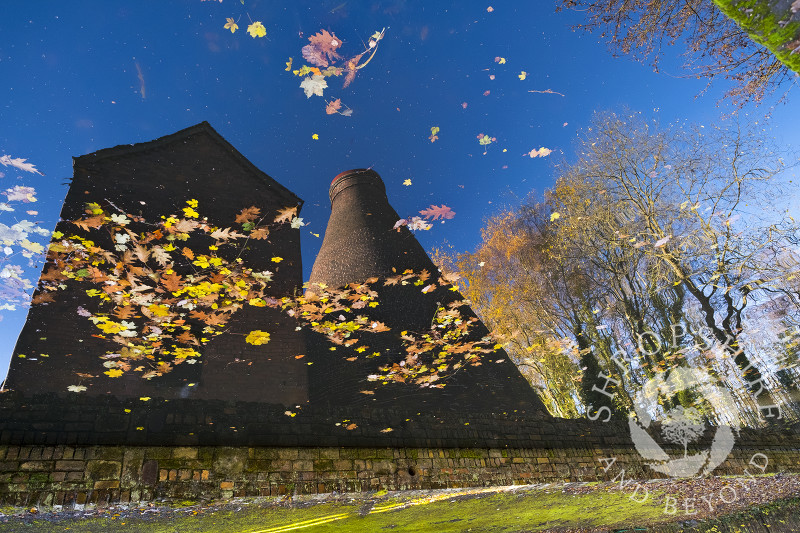 Coalport China Museum reflected in the waters of the Shropshire Canal, near Ironbridge, Shropshire.