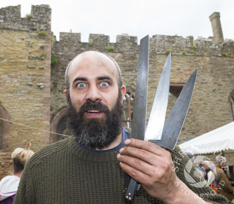Joel Black holding up a set of his kitchen knives at the 2017 Ludlow Spring Festival.