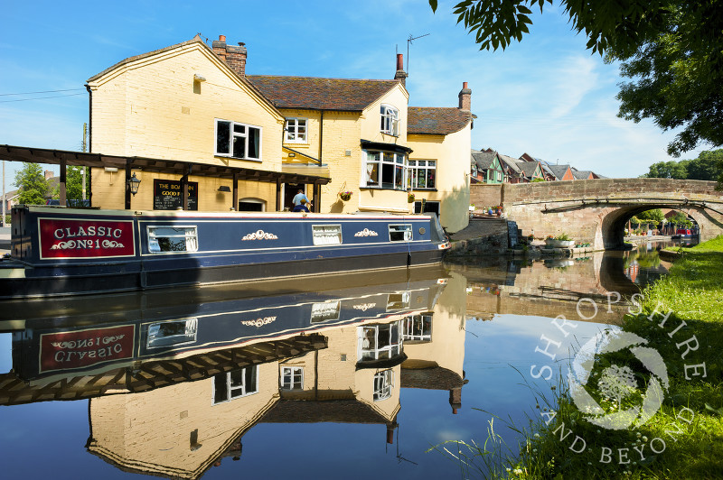 Reflections in the Shropshire Union Canal outside the Boat Inn at Gnosall, Staffordshire, England.