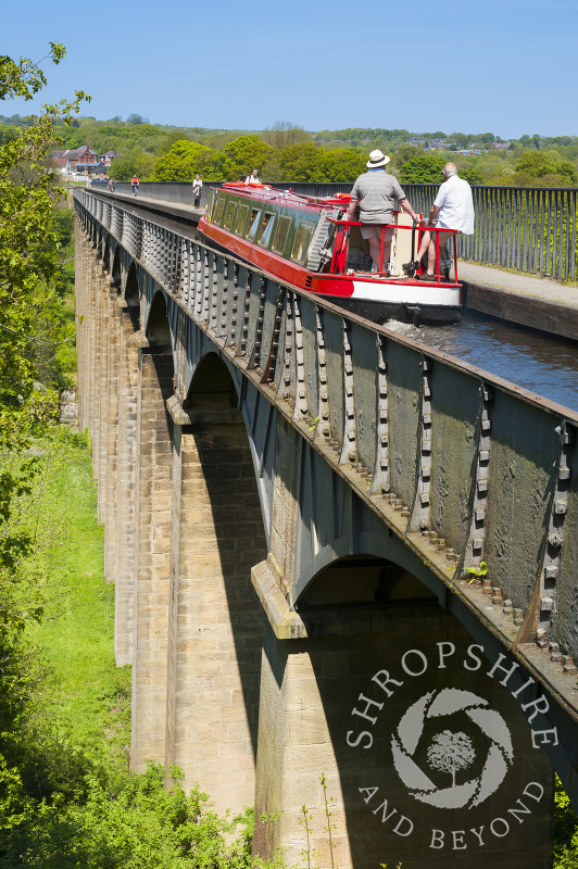 A narrowboat passes along the Llangollen Canal on the Pontcysyllte Aqueduct, North East Wales.