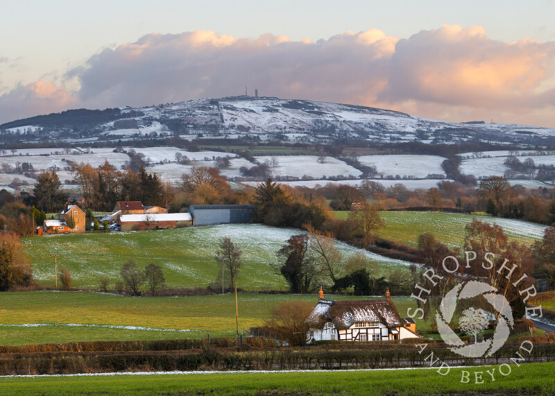 Evening light on a thatched cottage at Shipton, Shropshire, beneath Brown Clee.