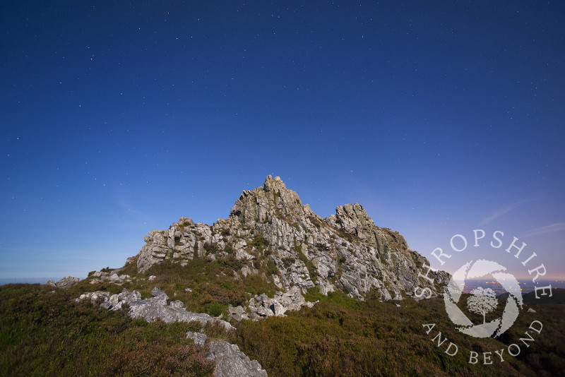 Moonlight illuminates the Devil's Chair rock formation on the Stiperstones, Shropshire. Overhead can be seen the Plough, part of the Ursa Major constellation.
