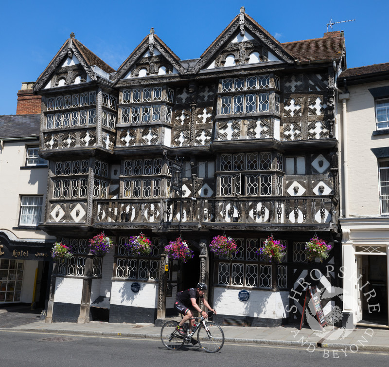 A cyclist rides past the Feathers Hotel at Ludlow, Shropshire, England.
