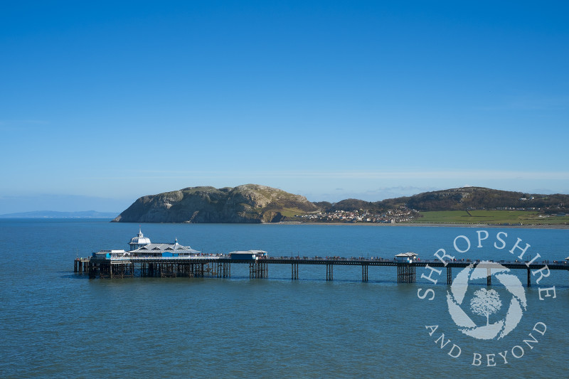 Blue sky over Llandudno Pier and the Little Orme, Llandudno, north Wales.