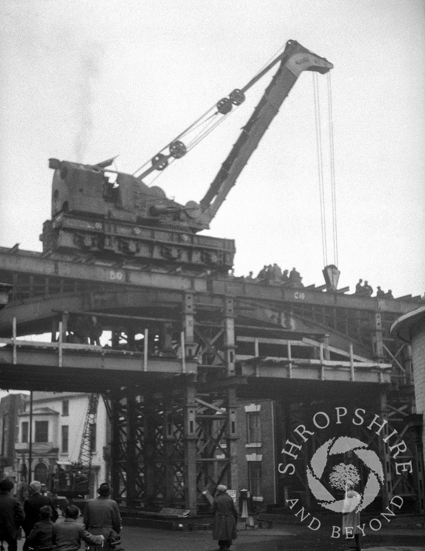 A crane lifting parts of the old railway bridge, Shifnal, Shropshire, 1953.