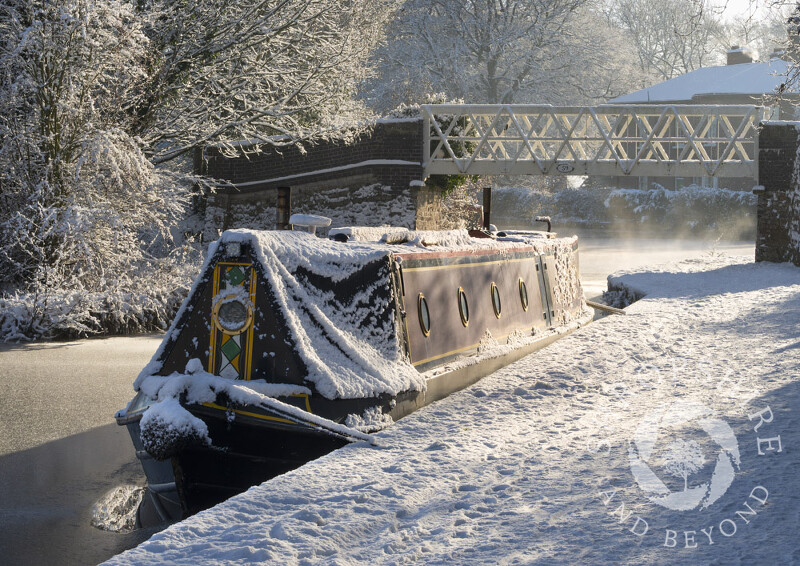 Snow-covered narrowboat on the Llangollen Canal, Ellesmere.