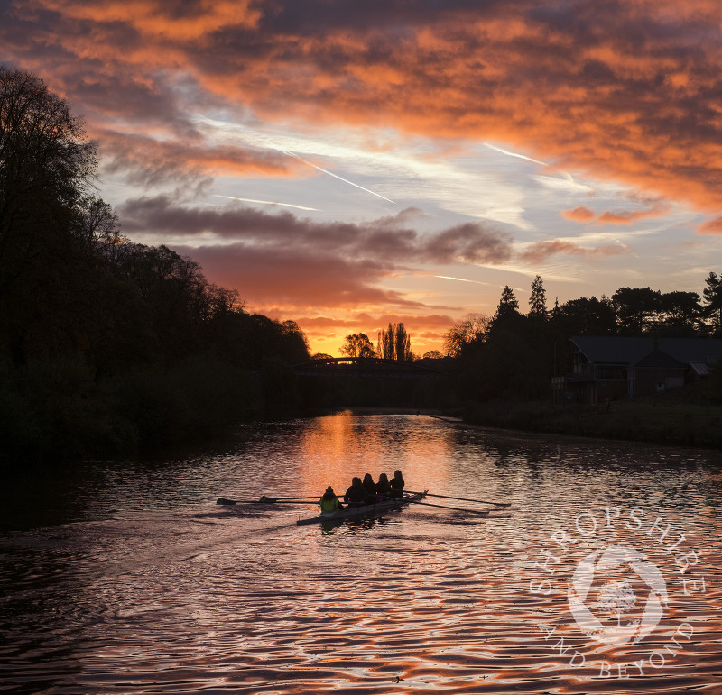 Rowers at sunrise on the River Severn at Shrewsbury, Shropshire.