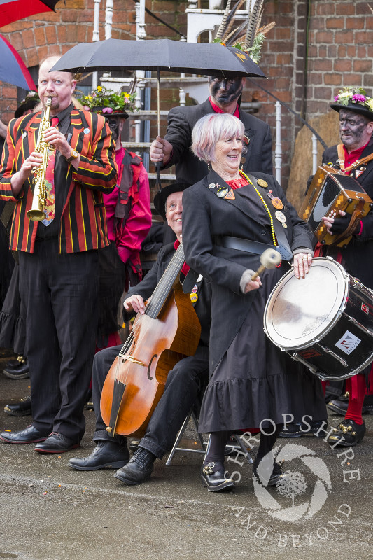 Musicians with Ironmen and Severn Gilders morris dancers performing in the rain at the Day of Dance, Bishop's Castle, Shropshire.