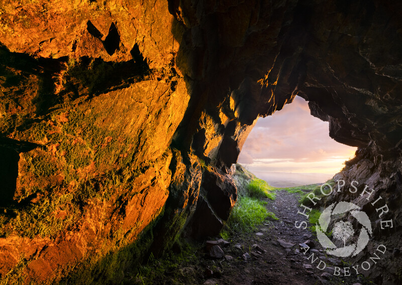 Sunset lights up the interior of Caractacus's Cave on Caradoc, Church Stretton, Shropshire.