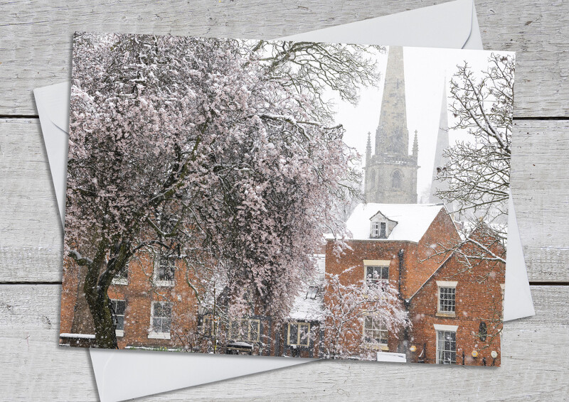Snow and blossom in the churchyard at Old St Chad's Shrewsbury, Shropshire
