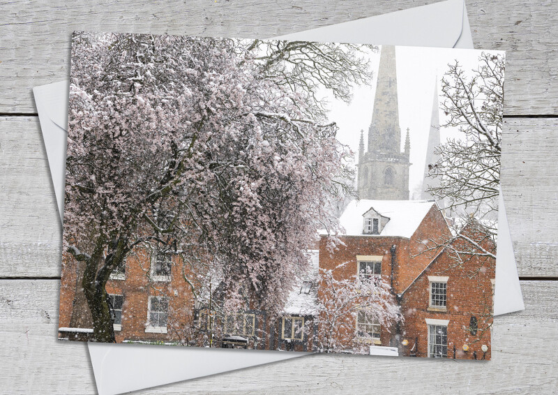 Snow and blossom in the churchyard at Old St Chad's Shrewsbury, Shropshire