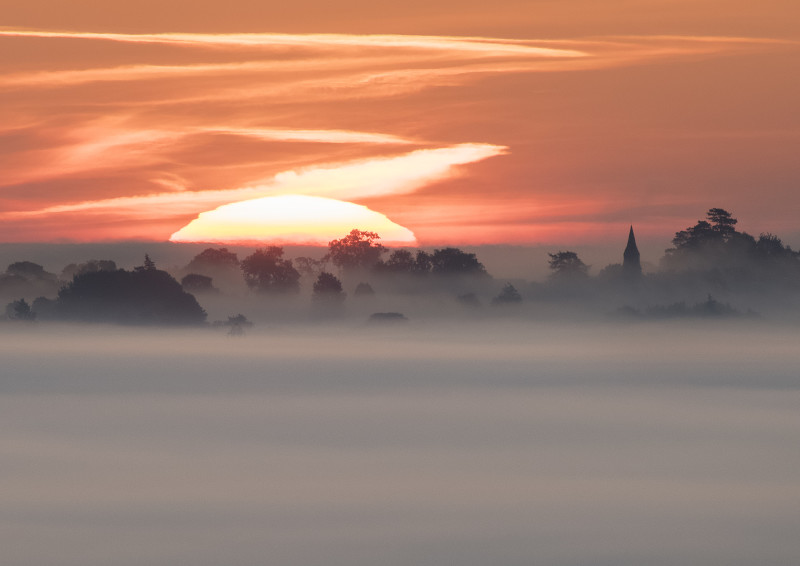 Sunrise near Welsh Frankton Church, seen from Old Oswestry Hill Fort.