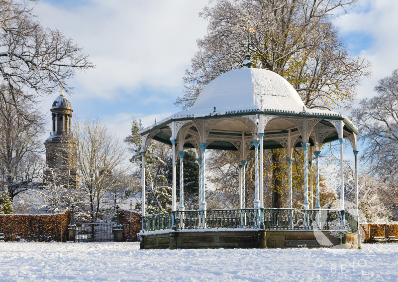 The bandstand in the Quarry overlooked by the tower of St Chad's Church, Shrewsbury, Shropshire.