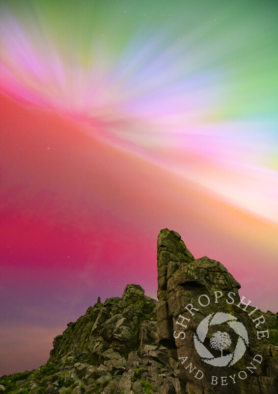 Northern lights shine over Manstone Rock on the Stiperstones, Shropshire.