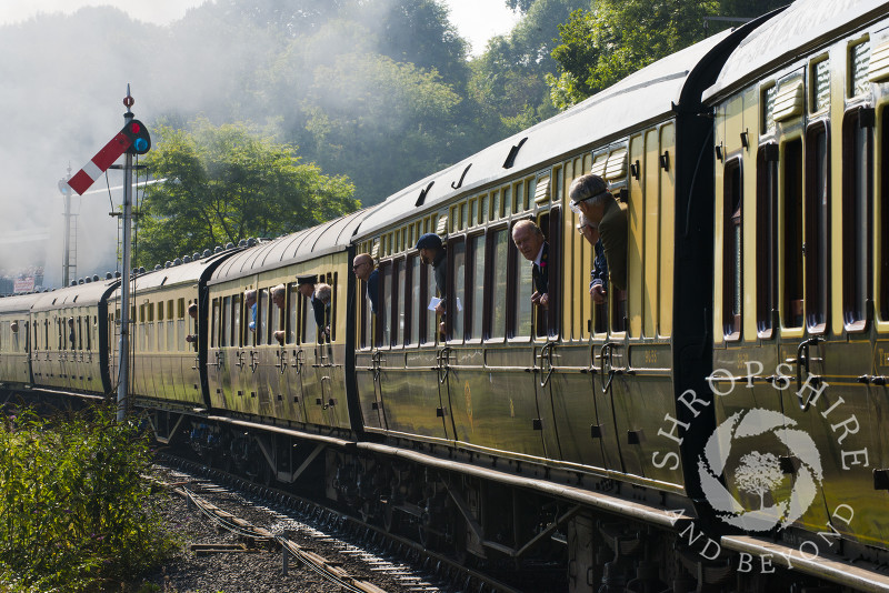 Passengers look out of carriage windows as they leave Highley Station, Shropshire, on the Severn Valley Railway heritage line.