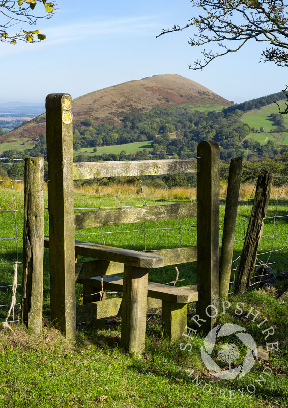 A stile beneath Caradoc at Church Stretton, looking to the Lawley, Shropshire.