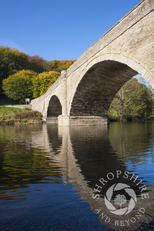 Dinham Bridge reflected in the River Teme in autumn, Ludlow, Shropshire, England.