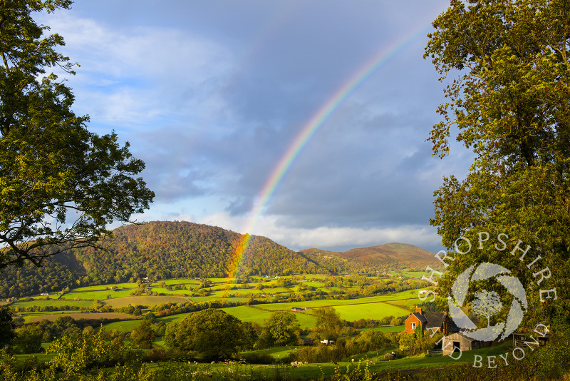 An autumn rainbow in front of the Breidden Hills, Powys, Wales.