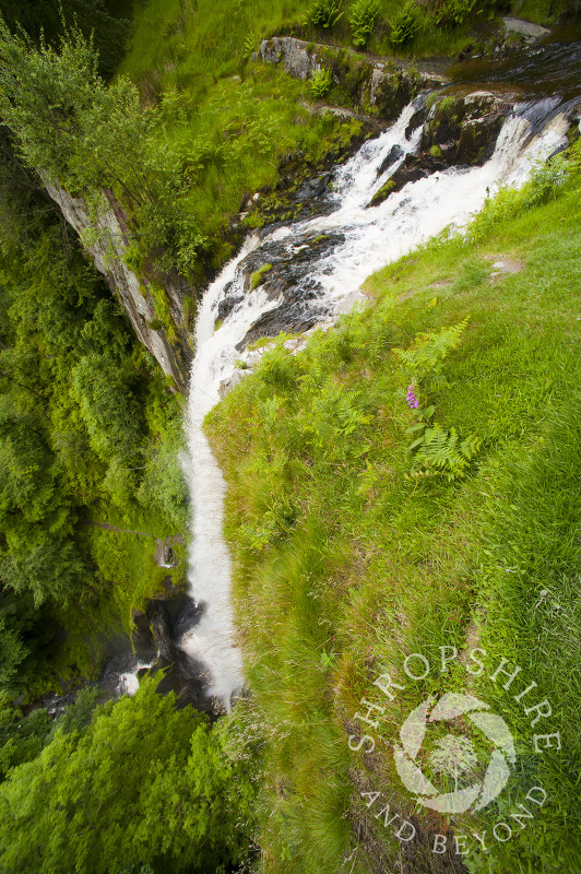 Water tumbles down Pistyll Rhaeadr waterfall in the Berwyn Mountains, Powys, Wales.
