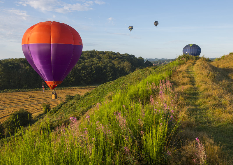 Hot air balloons get a close look at Old Oswestry Iron Age Hill Fort, Shropshire.