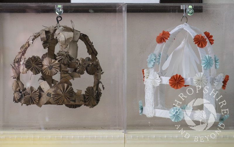 An 18th century maiden's garland alongside a modern replica on display in Holy Trinity Church, Minsterley, Shropshire.