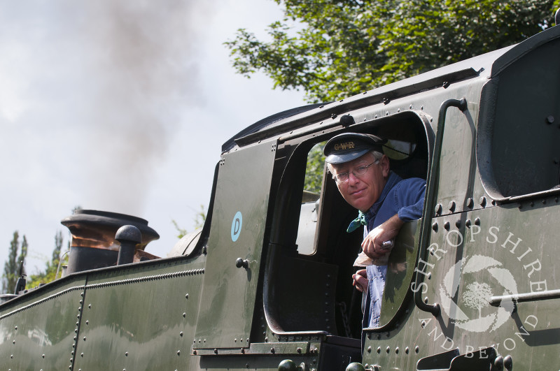 A driver looks out of the cab at Bridgnorth Station, Severn Valley Railway, Shropshire, England.