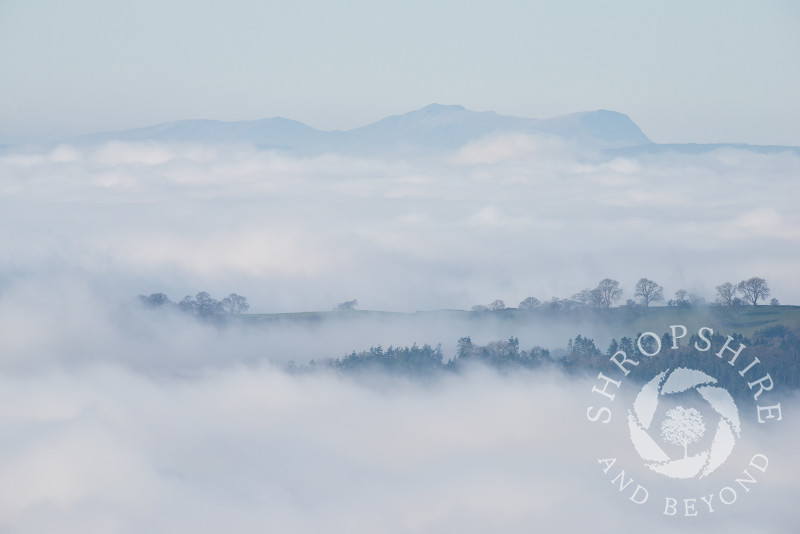 Mist over south Shropshire, seen from Bromlow Callow, with the Breidden Hills, Powys, in the distance.