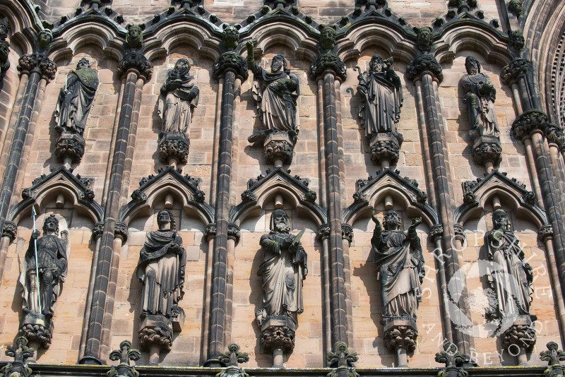 Carved figures on the ornate West Front of Lichfield Cathedral, Lichfield, Staffordshire, England.