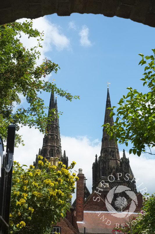 A view of Lichfield Cathedral seen through a gateway at Erasmus Darwin House in Lichfield, Staffordshire, England.