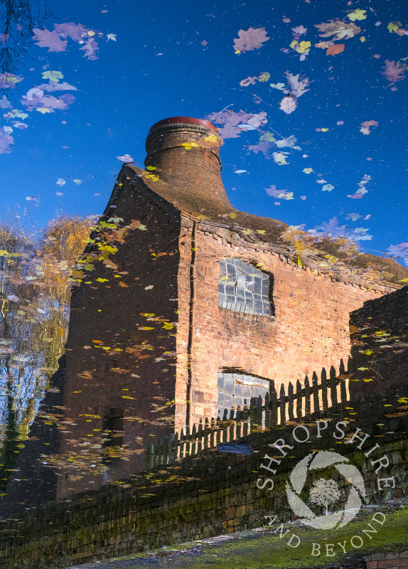 Coalport China Museum reflected in the waters of the Shropshire Canal, near Ironbridge, Shropshire.