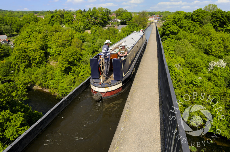 A narrowboat passes along the Llangollen Canal on the Pontcysyllte Aqueduct, North East Wales.