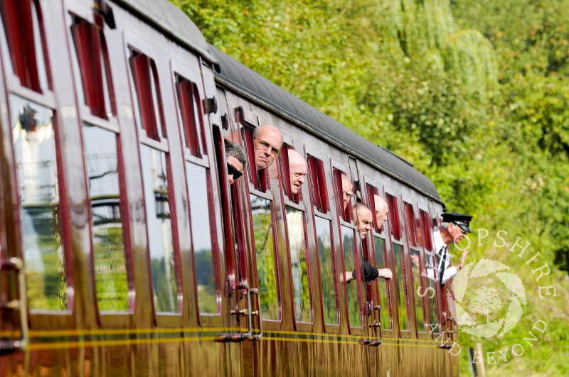 Passengers look out of carriage windows at Hampton Loade Station, Severn Valley Railway, Shropshire, England.