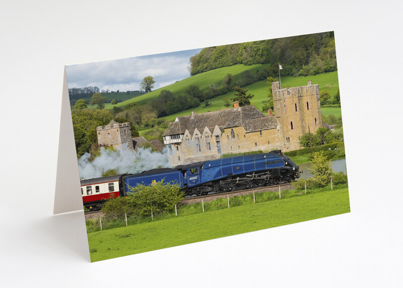 Steam locomotive Sir Nigel Gresley passes Stokesay Castle, Shropshire.