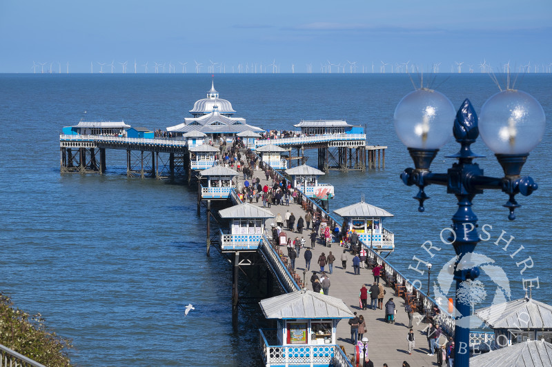 A busy day on Llandudno Pier, north Wales, looking towards the offshore wind farm.