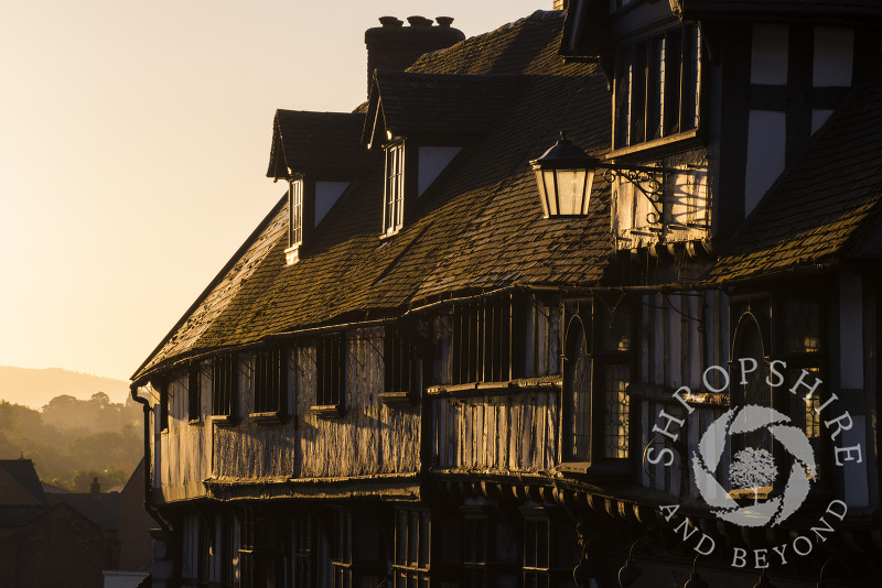 Sunrise illuminates half-timbered buildings on Wyle Cop, Shrewsbury, Shropshire.