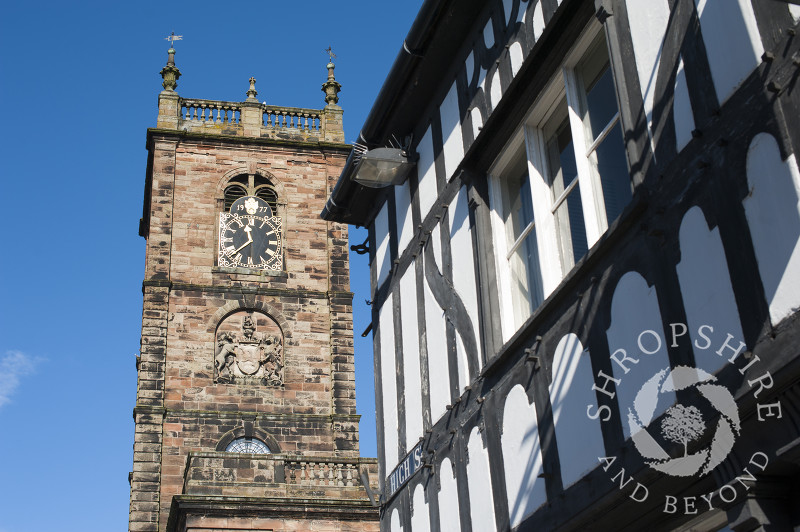 The tower of St Alkmund's Church and a half-timbered building in Whitchurch, Shropshire, England.