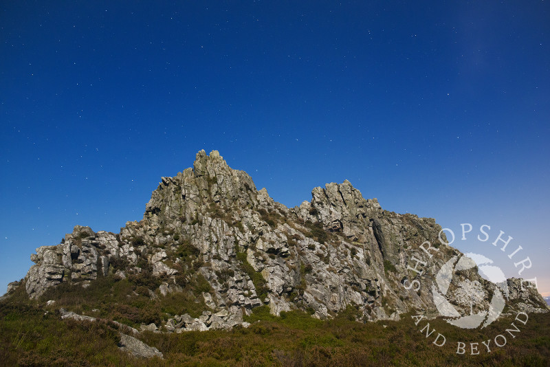 Moonlight illuminates the Devil's Chair rock formation on the Stiperstones, Shropshire. Overhead is the Plough, part of the Ursa Major constellation.