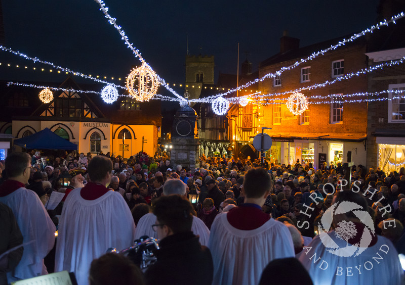 Carol singing in the Square at Much Wenlock, Shropshire, with Holy Trinity Church seen in the background.