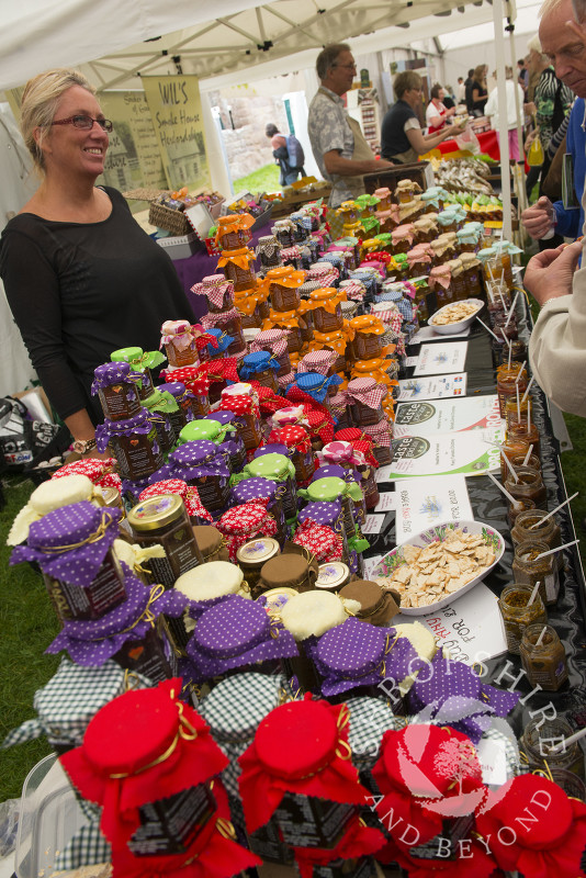 Heather Williams of Heather's Harvest with jars of preserves at Ludlow Food Festival, Shropshire.