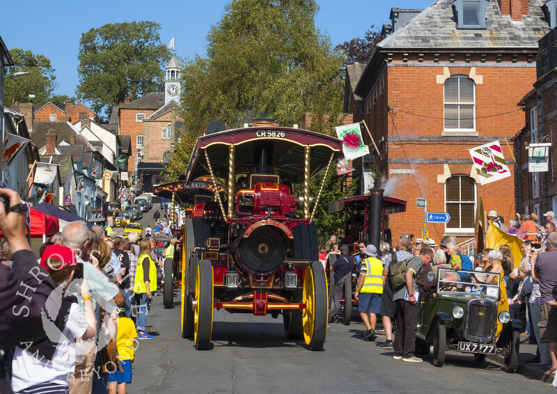 Traction engines parade down High Street at the Michaelmas Fair, Bishop's Castle, Shropshire.