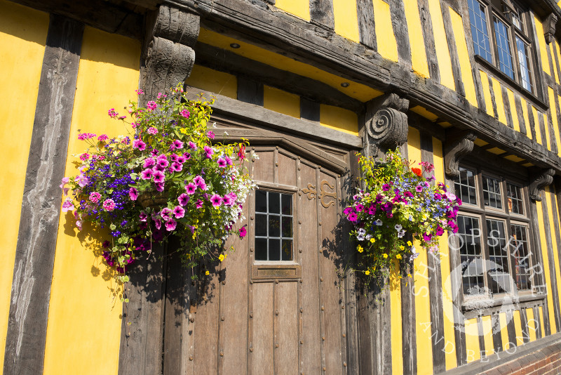 Hanging baskets outside half-timbered house in Broad Street, Ludlow, Shropshire, England.