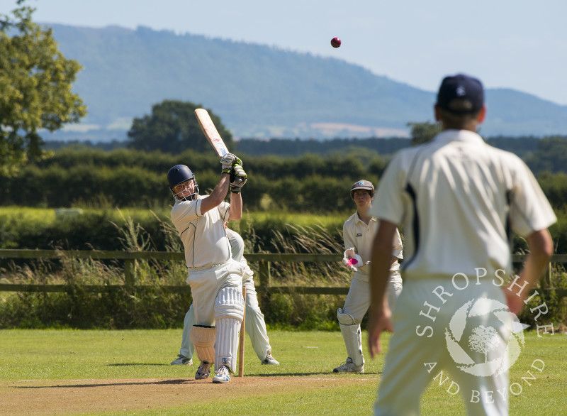 Acton Reynald Cricket Club 2nd XI batting against Shrewsbury 4th XI at Grinshill, Shropshire. The Wrekin is seen in the distance.