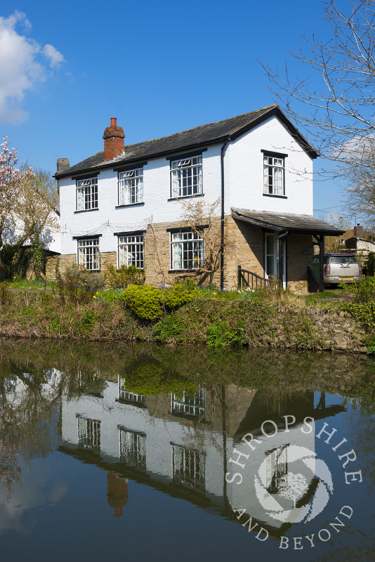 A house reflected in the River Arrow at Eardisland, Herefordshire, England.