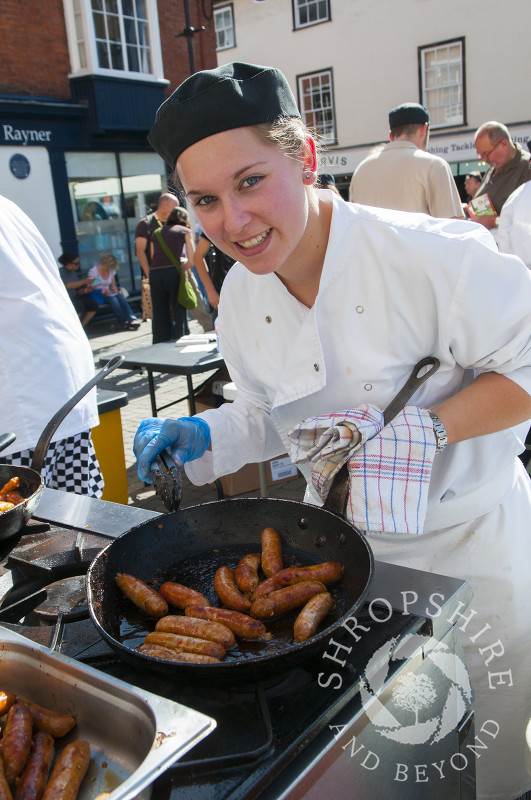 Cooking sausages for visitors taking part in the Sausage Trail at Ludlow Food Festival, Shropshire, England.